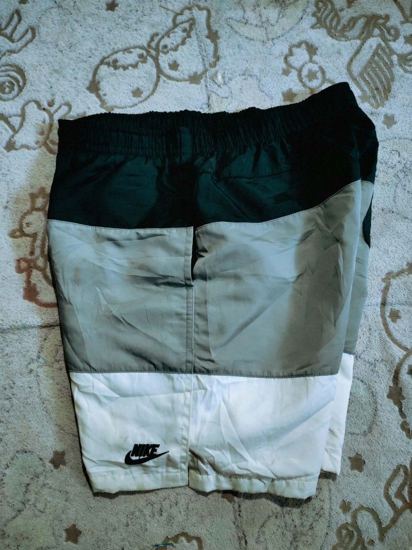 Nike Colorblock Nylon Shorts (Category: Shorts) located in Sipalay. Submitted by boldowl.e4f283 (Listing ID 1469530896, Image 3). Description: - Brand: Nike - Size: Large - Design: Tri-color block (Dark Green, Grey, White) - Material: Nylon with comfortable inside mesh lining - Features: Elastic waistband with adjustable drawstring, embroidered Nike logo, and single back pocket with button closure - Origin: Made in Vietnam.