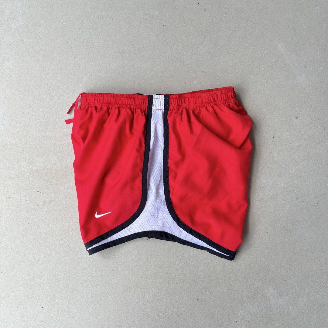 Nike Dri-FIT Red Running Shorts Size (Category: Shorts) located in Mandaue City. Submitted by chinsyap_03 (Listing ID 1469461906, Image 2). Description: - Brand: Nike - Type: Dri-FIT Athletic Running Shorts - Color: Red with white mesh side panels and black trim - Waistband: Elastic with adjustable drawstring - Logo: Iconic small white swoosh on the front leg - Material: Lightweight and breathable fabric for maximum comfort - Condition: Excellent