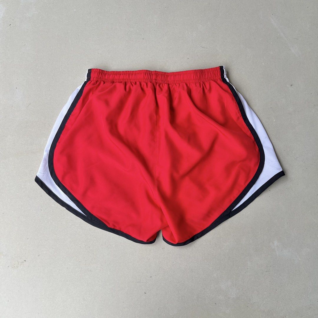 Nike Dri-FIT Red Running Shorts Size (Category: Shorts) located in Mandaue City. Submitted by chinsyap_03 (Listing ID 1469461906, Image 3). Description: - Brand: Nike - Type: Dri-FIT Athletic Running Shorts - Color: Red with white mesh side panels and black trim - Waistband: Elastic with adjustable drawstring - Logo: Iconic small white swoosh on the front leg - Material: Lightweight and breathable fabric for maximum comfort - Condition: Excellent