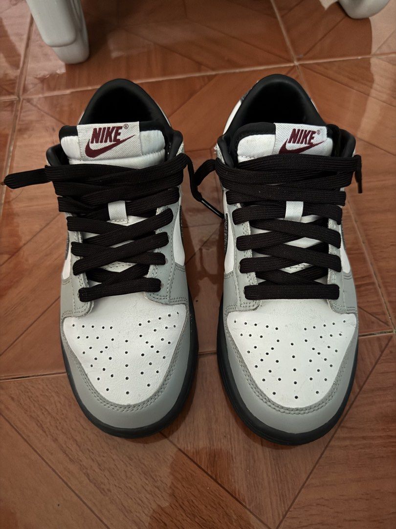Nike Dunk Low Grey Glitter Swoosh (Category: Sneakers) located in Lipa City. Submitted by prelovedcheckout (Listing ID 1469452580, Image 2). Description: - Model: Nike Dunk Low - Colorway: Grey and white with dark soles and black laces - Special Features: Sparkly glitter on the swoosh and heel tab - Comfort & Design: Classic leather upper, perforated toe box, and extra-padded tongue with a vintage style tag - Condition: Clean and ready to wear.