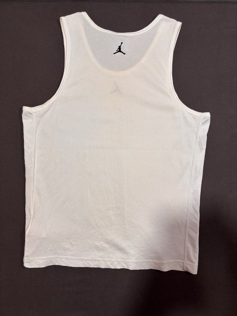Nike Jordan White Ribbed Tank Top (Category: Sleeveless) located in Mabalacat. Submitted by _limitlessfashion (Listing ID 1469403696, Image 3). Description: - Brand: Nike Jordan - Color: White - Size: 3XL - Length 28.5 - Width 21 - No major issue, need wash only - Material: Dri-FIT technology fabric - Details: Ribbed texture, embroidered Jumpman logo on chest and upper back, small Jordan tag on lower hem - Condition: Clean and ready to wear.