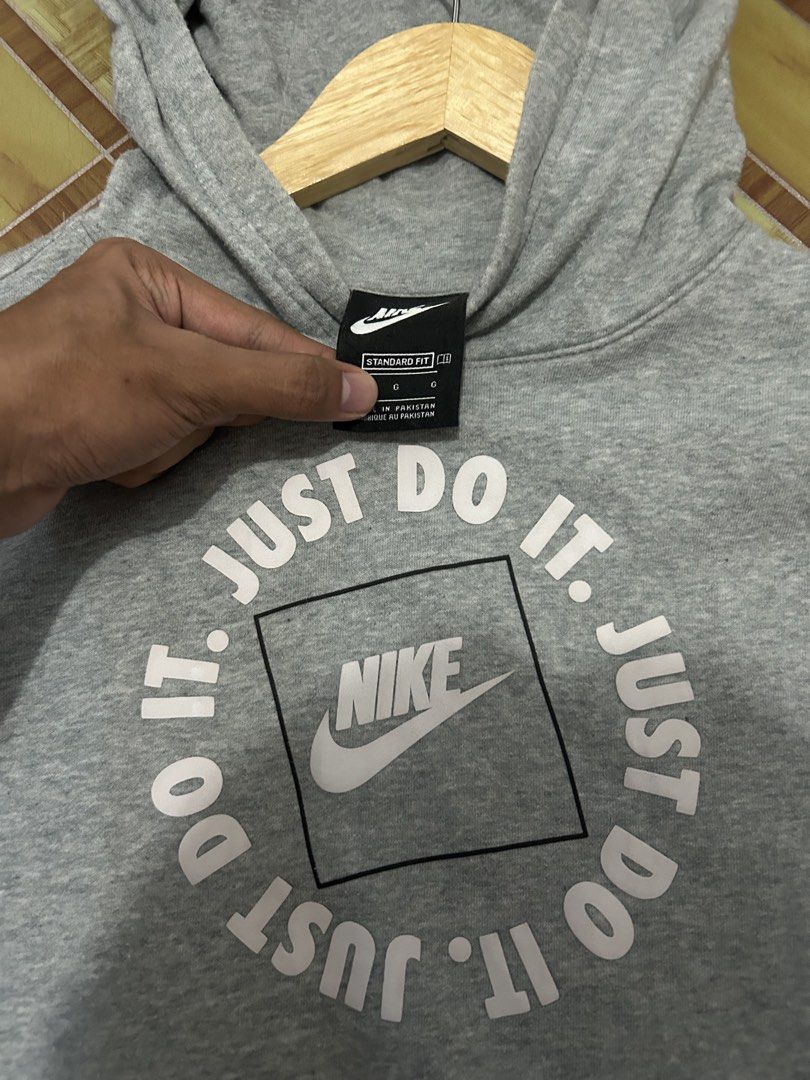 Nike Just Do It Grey Hoodie Size L (Category: Hoodies) located in Manila. Submitted by garmentfinds.01 (Listing ID 1469520963, Image 1). Description: - Authentic grey Nike pullover hoodie - Bold 'Just Do It' circular graphic on the front - Classic kangaroo pocket and standard fit - Size L (Tag indicates fit for ages 12 to 13) - Material: 80% cotton, 20% polyester body; 100% cotton hood lining - Warm, soft, and comfortable for daily use - Made in 