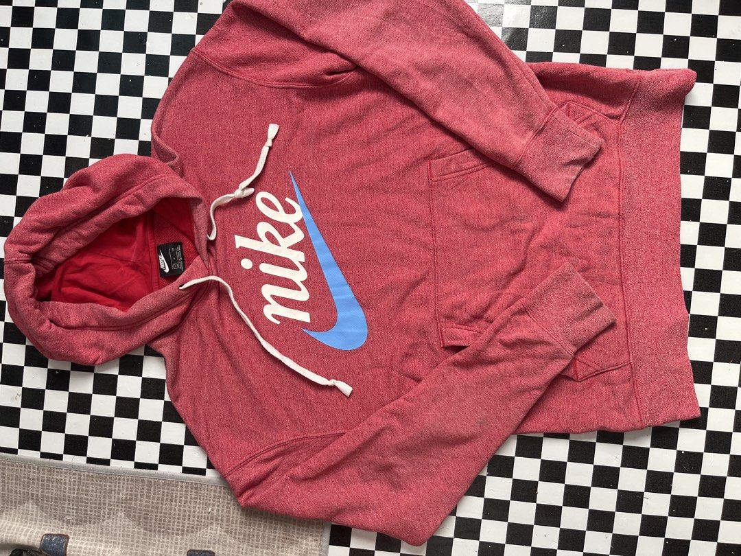 Nike Red Blue Script Logo Pullover Hoodie (Category: Hoodies) located in Manila. Submitted by joebertbar04956 (Listing ID 1469449535, Image 2). Description: - Brand: Nike - Size: S (tag on collar) - Color: Red heathered with contrast blue swoosh and white lettering - Design: Large script logo across the chest, adjustable drawstring hood with red interior lining - Features: Front kangaroo pocket, ribbed cuffs and hem - Material: Cotton and polyest