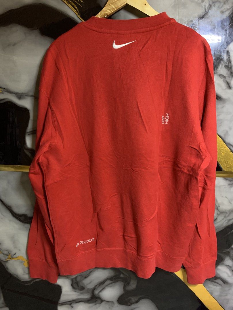 Nike Red Crewneck Sweatshirt with Chest Patch (Category: Coats, Jackets and Outerwear) located in Davao. Submitted by youngboythrift25 (Listing ID 1469426876, Image 3). Description: - Color: Bright red - Design: Classic crewneck with long sleeves - Branding: Stitched Nike patch on left chest - Comfort: Soft interior fleece lining with shape-retaining ribbed cuffs and hem - Styling: Great for cooler weather, pairs easily with jeans or joggers - Co