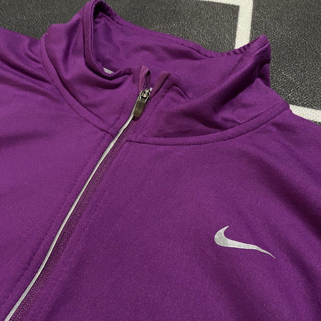 Nike Running Dri-fit Pacer (Category: Coats, Jackets and Outerwear) located in Villasis. Submitted by thriftngrind (Listing ID 1469435548, Image 2). Description: - Brand: Nike - Color: Purple - Dimension: 21 Width X 26 Length - Style: Long sleeve running pullover with half-zip neck and metallic swoosh logo - Features: Convenient thumbholes at cuffs - Fabric: Lightweight and stretchy for active wear .