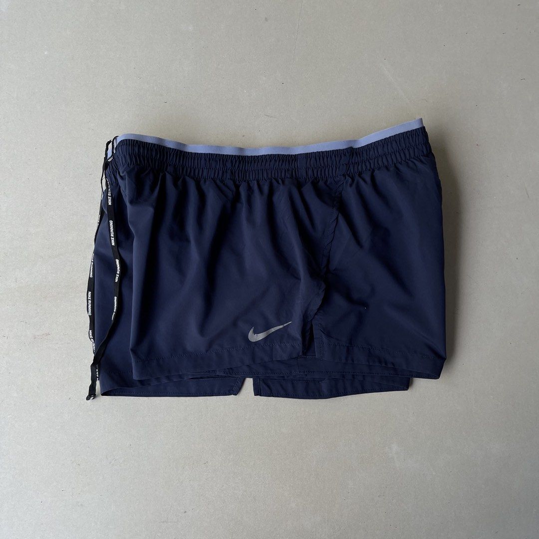 Nike Running Shorts Navy Blue Drawstring (Category: Shorts) located in Mandaue City. Submitted by chinsyap_03 (Listing ID 1469461989, Image 2). Description: - Brand: Nike - Color: Dark Navy Blue - Size: Standard fit (Lightweight material) - Features: Elastic waistband with grey inner band & branded drawstring - Details: Reflective swoosh logo near hem + secure back zip pocket - Condition: Clean and well-maintained.