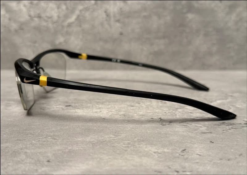 Nike semi-rimless glasses with case (Category: Sunglasses & Eyewear) located in Baguio. Submitted by gokubusansan (Listing ID 1469559964, Image 3). Description: - Brand: Nike - Frame Type: Semi-rimless - Color: Black with yellow temple accents - Logo: Subtle Nike swoosh on the side - Lenses: Clear (ready for your prescription lenses) you can have it replaced with pop-in replacement lenses - Inclusions: Matching black hardshell case with silver Ni