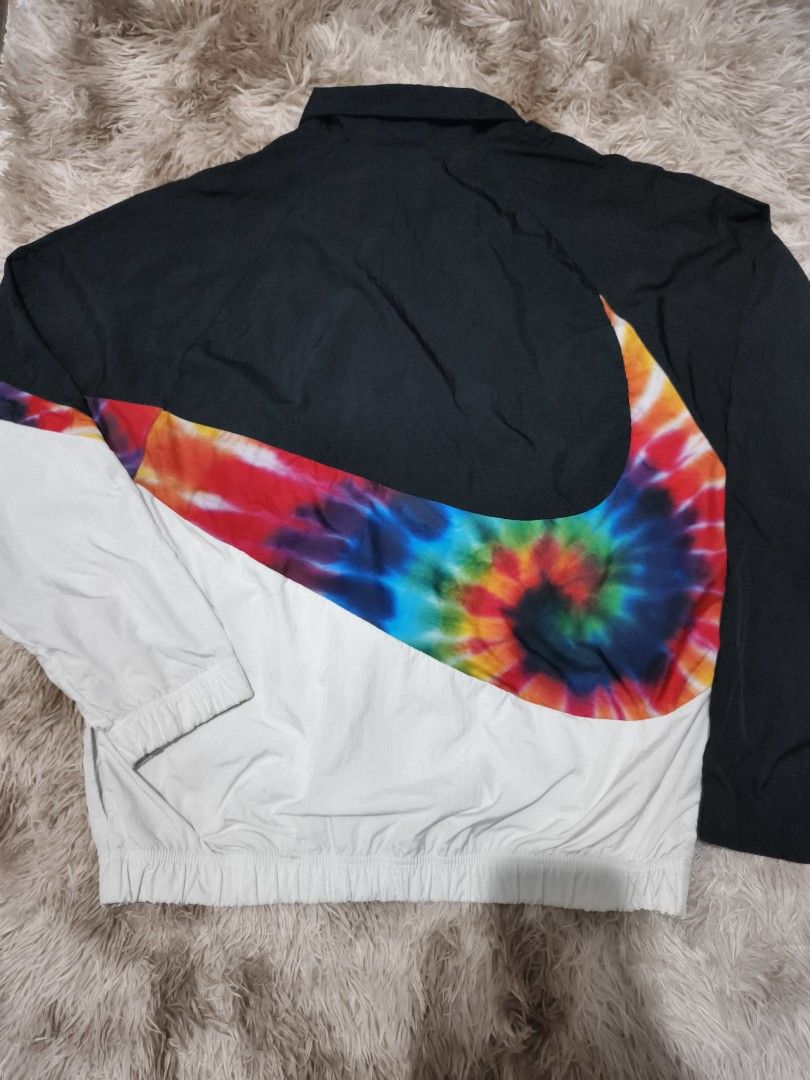 Nike Tie-Dye Swoosh Full-Zip Windbreaker Jacket (Category: Coats, Jackets and Outerwear) located in Quezon City. Submitted by hghthrft (Listing ID 1469487854, Image 2). Description: - Brand: Nike - Style: Tie-dye windbreaker jacket (CI9598-010) - Color: Black, white, and multicolored - Size: Medium - Design: Giant swoosh graphic across chest and back - Features: Full-zip front, stand-up collar, elastic cuffs and hem - Origin: Made in Vietnam.
