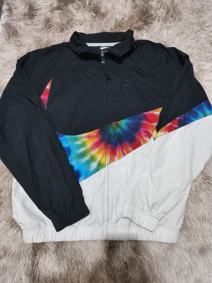 Nike Tie-Dye Swoosh Full-Zip Windbreaker Jacket (Category: Coats, Jackets and Outerwear) located in Quezon City. Submitted by hghthrft (Listing ID 1469487854, Image 1). Description: - Brand: Nike - Style: Tie-dye windbreaker jacket (CI9598-010) - Color: Black, white, and multicolored - Size: Medium - Design: Giant swoosh graphic across chest and back - Features: Full-zip front, stand-up collar, elastic cuffs and hem - Origin: Made in Vietnam.