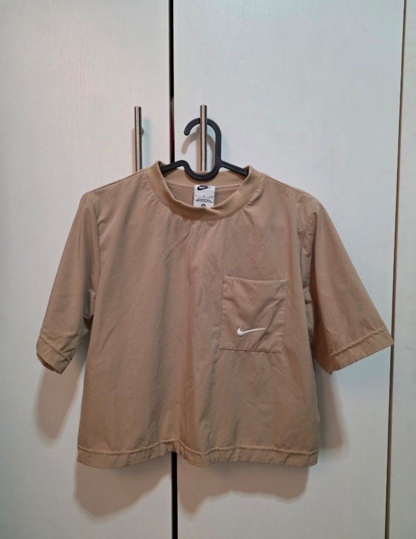 Nike Top (Category: Blouses) located in Mandaluyong City. Submitted by qnnrslmvrdn (Listing ID 1469492365, Image 1). Description: Beige Small Nike cropped top. Bought from outlet store. Please only communicate with me through Carousell..