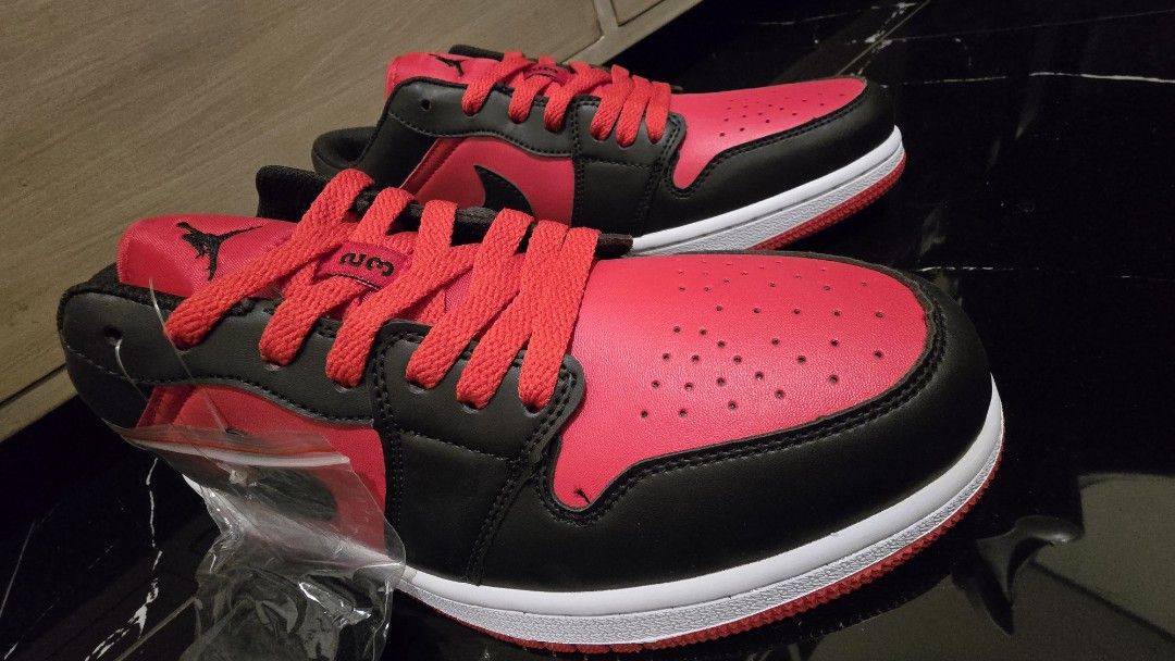 Nike US size 9.5 (Category: Sneakers) located in Quezon City. Submitted by ShoesManila (Listing ID 1469538934, Image 3). Description: Nike US size 9.5 men Air Jordan 1 Low sneakers in red and black colorway. Classic leather upper, perforated toe box, signature Swoosh branding on the sides. Jumpman logo on the tongue, embroidered Wings logo on the heel counter. White midsole paired with red rubber outsole for traction. Extra laces included in a pl