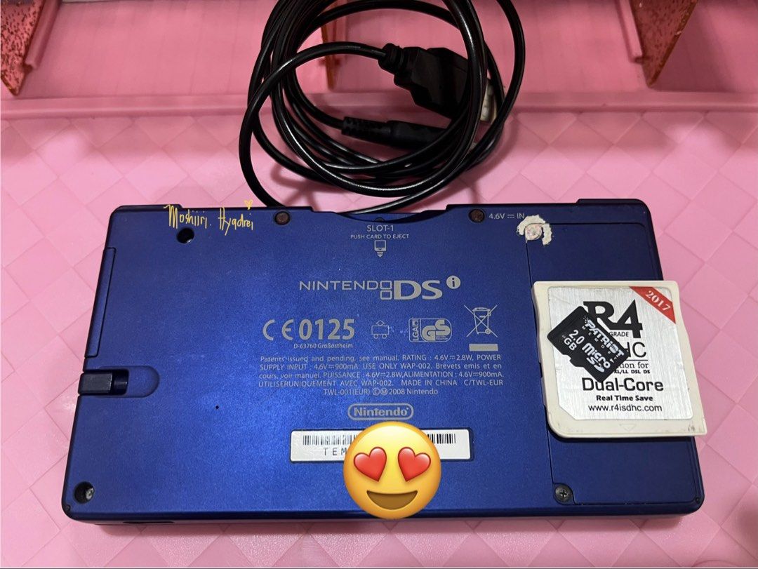 Nintendo DSi - Metallic Blue (Category: Nintendo) located in Valenzuela. Submitted by moshiiri_kawaii_v2 (Listing ID 1469549733, Image 2). Description: Nintendo DSi - Metallic Blue Working touch screen, buttons and dual cameras, Seems not yet repaired - Intact sticker warranty With 25 games installed Goods battery life Inclusion : Unit, R4 with 2gb microsd, orig stylus, replacement power cord (adaptor not included) Flaws: minimal scratches, Scree