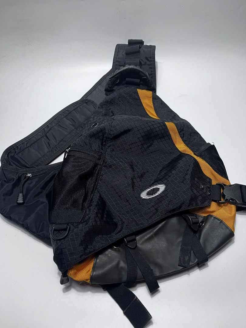 Oakley Sling Backpack Black Yellow (Category: Backpacks) located in Iloilo. Submitted by fromthebins.ilo2 (Listing ID 1469463930, Image 1). Description: - 100% durable nylon with stylish ripstop fabric panels - Bold black and yellow colorway with rubberized 'Mad Science, High Voltage' shoulder strap badge - Convenient mesh outer pocket and secure zip closures for great storage - Adjustable waist and shoulder straps with heavy-duty quick-release b