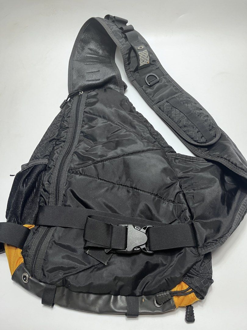 Oakley Sling Backpack Black Yellow (Category: Backpacks) located in Iloilo. Submitted by fromthebins.ilo2 (Listing ID 1469463930, Image 2). Description: - 100% durable nylon with stylish ripstop fabric panels - Bold black and yellow colorway with rubberized 'Mad Science, High Voltage' shoulder strap badge - Convenient mesh outer pocket and secure zip closures for great storage - Adjustable waist and shoulder straps with heavy-duty quick-release b