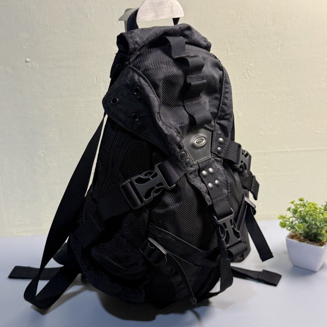 Oakley Technical Black Tactical Backpack (Category: Backpacks) located in Bago City. Submitted by g___shop (Listing ID 1469500459, Image 3). Description: - Brand: Oakley - Color: Black - Material: Textured mesh with structured shape - Hardware: Heavy-duty buckles, utility clips, and secure zip closures - Features: Multiple adjustable straps for a secure fit - Best for: Daily commute, hiking adventures, or elevated streetwear style.
