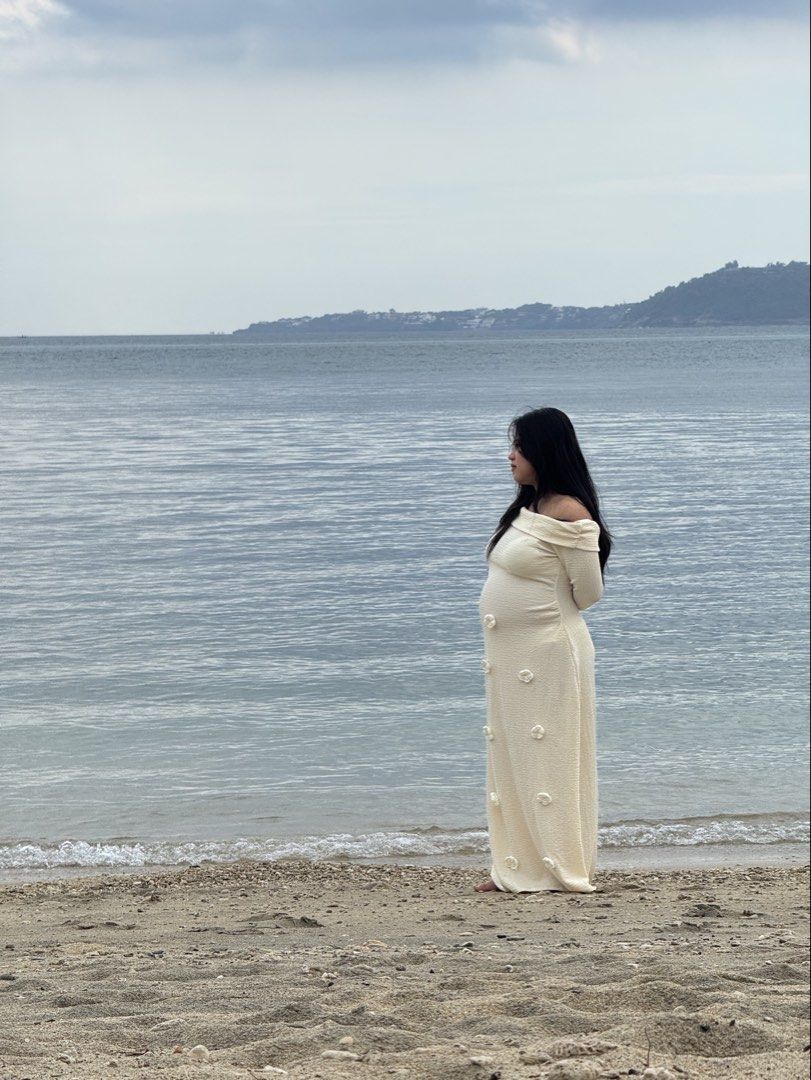Off-shoulder maternity dress (Category: Dresses) located in Tagaytay City. Submitted by bohodreamer (Listing ID 1469407638, Image 2). Description: - Color: Cream - Style: Off-shoulder, full-length maternity dress with long sleeves - Material: Stretchy textured knit fabric that comfortably hugs the bump - Details: Cute 3D floral appliqués scattered down the front - Condition: Worn once for a beach photoshoot, freshly washed and ready for the next 