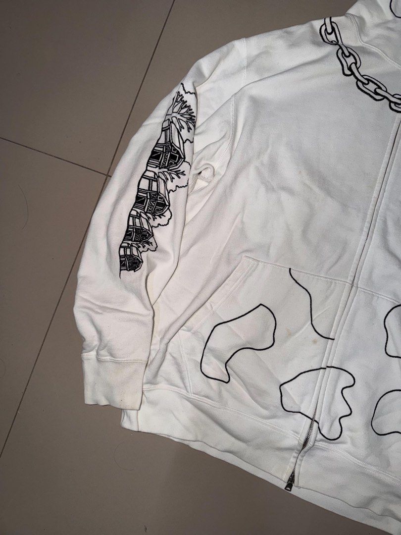 OG BAPE HOLSTEIN COW FULL ZIP (Category: Hoodies) located in Manila. Submitted by sleamdaily222 (Listing ID 1469555021, Image 3). Description: - Color: White with unique graphic prints - Design: Full-face cartoon graphic on hood, chain prints around neck, farmhouse prints on sleeves, cow spot outlines on front pockets, and back padlock detail - Hardware: Double zipper - Condition: Pre-owned with minor yellowing stains on the front and near the po