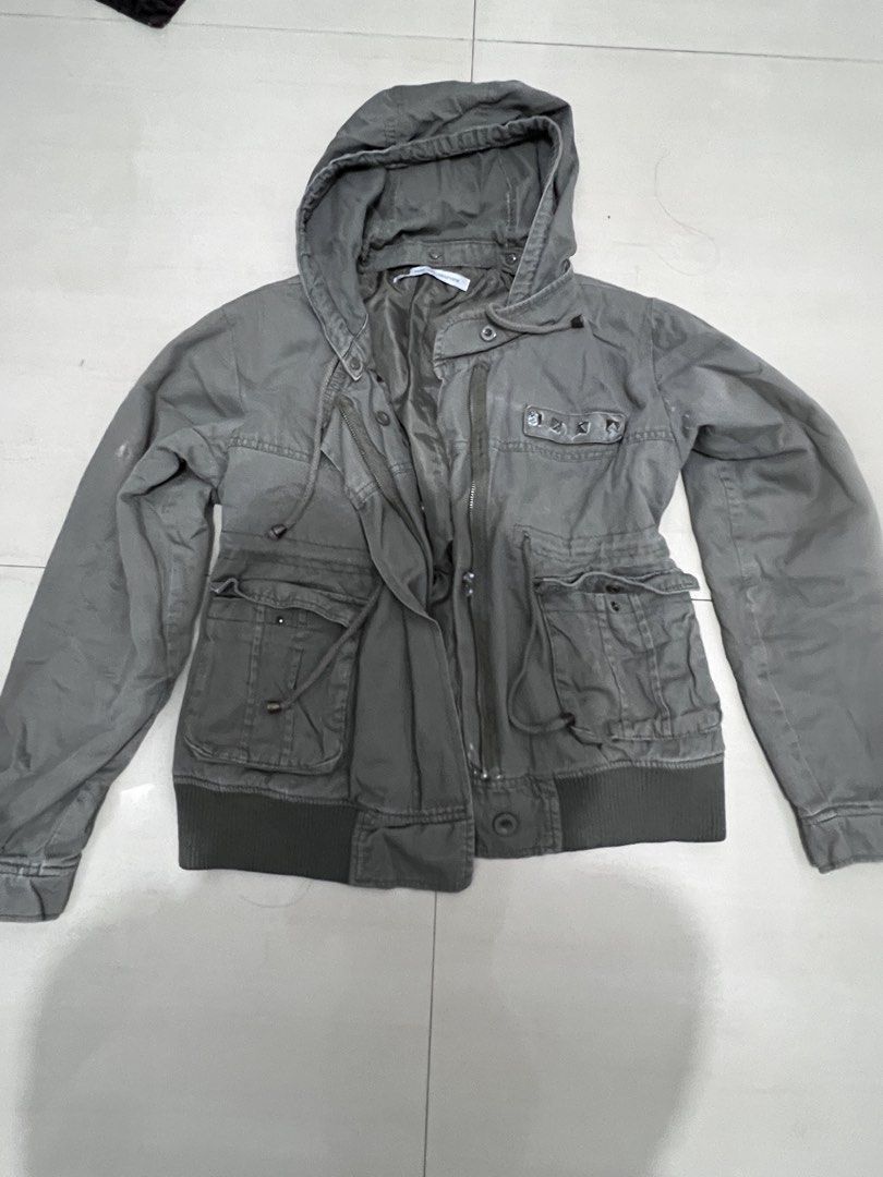 olive green studded cinchable hooded utility jacket (Category: Coats, Jackets and Outerwear) located in Caloocan City. Submitted by guaconerva97479 (Listing ID 1469556195, Image 2). Description: - Color: Olive green - Style: Casual utility jacket - Closure: Full front zipper with snap buttons - Hood: Built-in hood - Waist: Adjustable drawstring - Pockets: Two large front flap pockets and a chest pocket with stud detail - M-L - ramona flowers typa