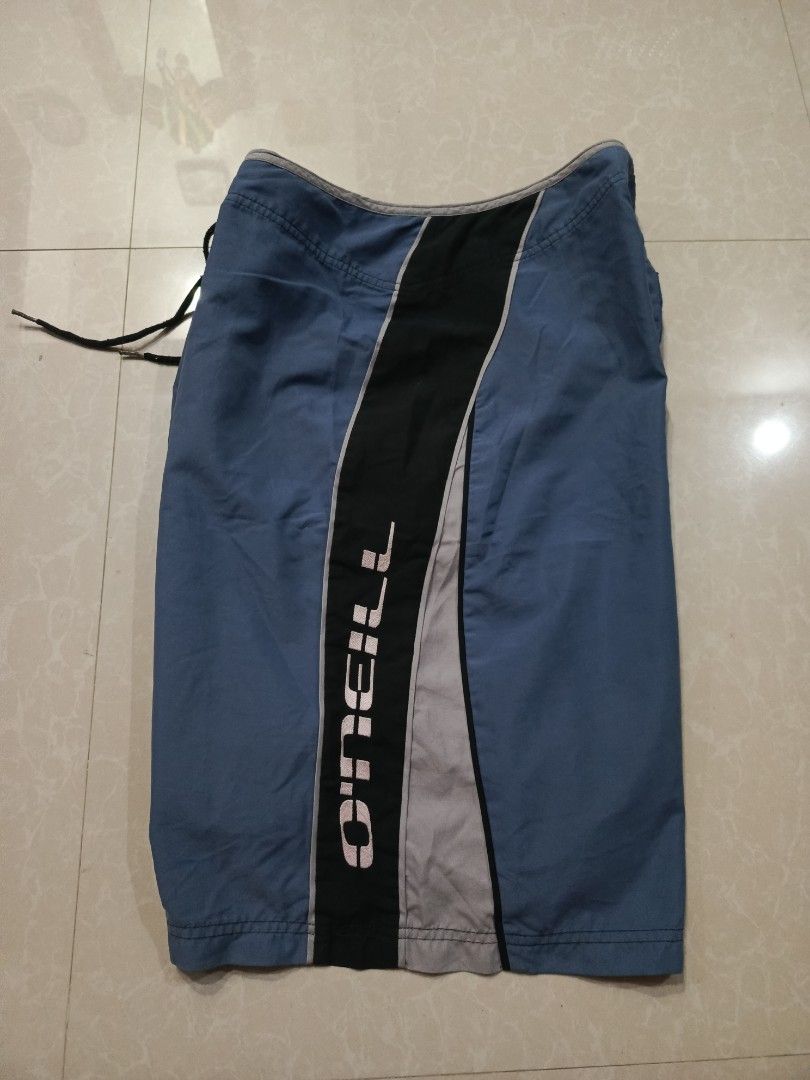 O'Neill Board Shorts Blue Black Surf Trunks (Category: Swim Trunks & Board Shorts) located in Cabatuan. Submitted by penthegreat (Listing ID 1469411441, Image 3). Description: 880+ship - Brand: O'Neill - Colorway: Blue and black with stylish grey panel accents - Logos: White brand text down the left leg and smaller logo on the lower right - Waist: Adjustable front drawstring closure - Pocket: Single back pocket with secure flap and logo tab - Fit