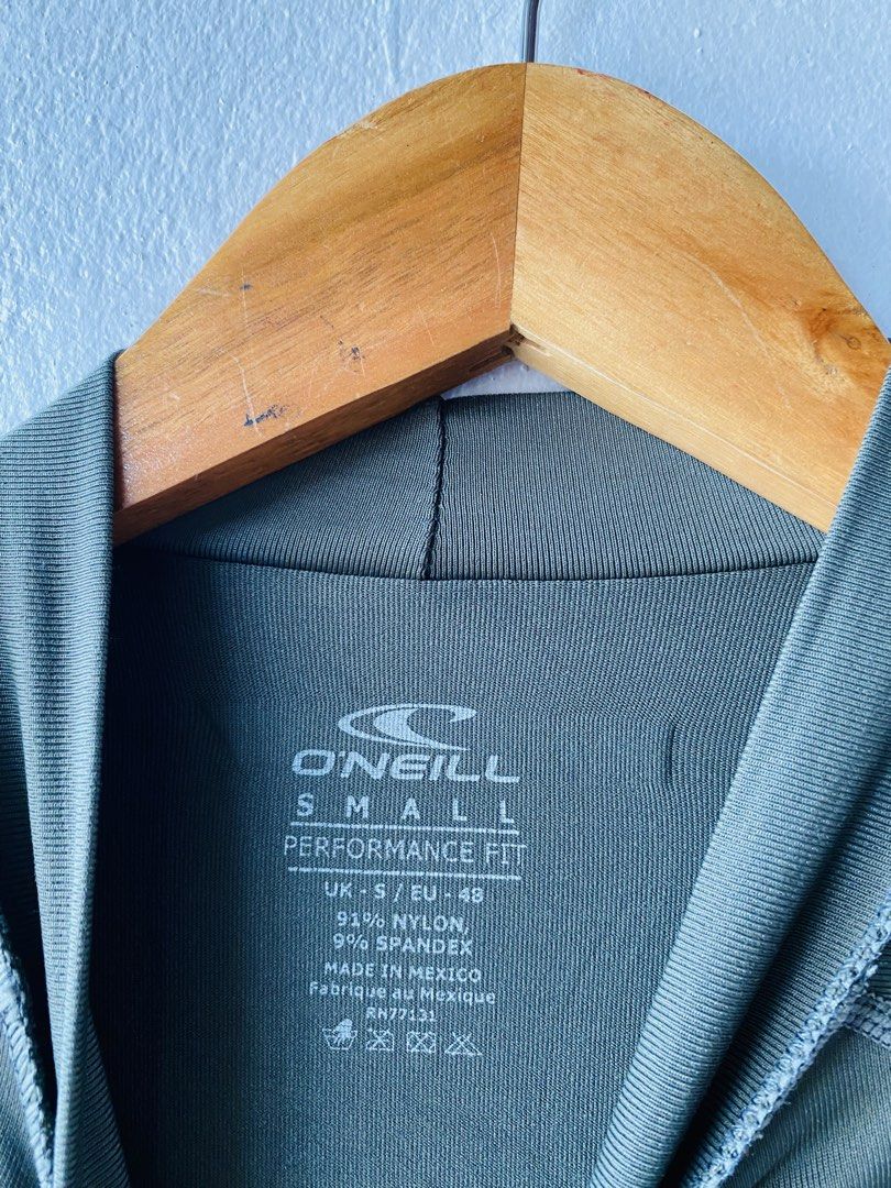 O'Neill Performance Fit Rash Guard (Category: Activewear) located in Caloocan City. Submitted by lovemyclothes21 (Listing ID 1469407488, Image 3). Description: - Brand: O'Neill - Type: Long Sleeve Performance Fit Rash Guard - Color: Green and Dark Grey with contrast side panels and neck collar - Size: Small (UK-S / EU-48) - Material: 91% nylon, 9% spandex - Features: Great stretch, lightweight - Ideal for: Surfing, swimming, and water sports.