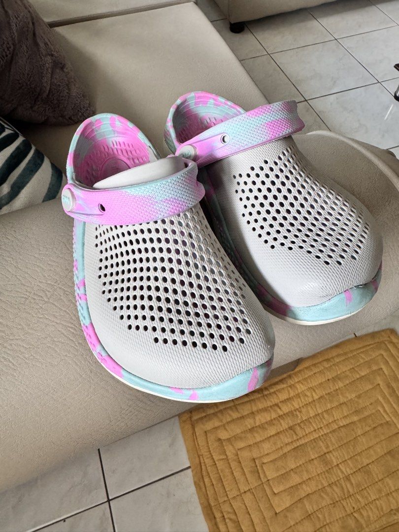 Original Crocs LiteRide Clogs Tie Dye Pink Blue Size J2 (Category: Slippers and slides) located in Batangas. Submitted by ayeeftz (Listing ID 1469421863, Image 1). Description: - Brand: Crocs - Model: LiteRide Clogs - Color: Grey with pink and blue tie-dye straps - Features: Breathable perforated uppers, super comfortable foam footbeds, and pivoting heel straps with embossed logo - Sizing: Exact measured length shown with tape in the photos - Per