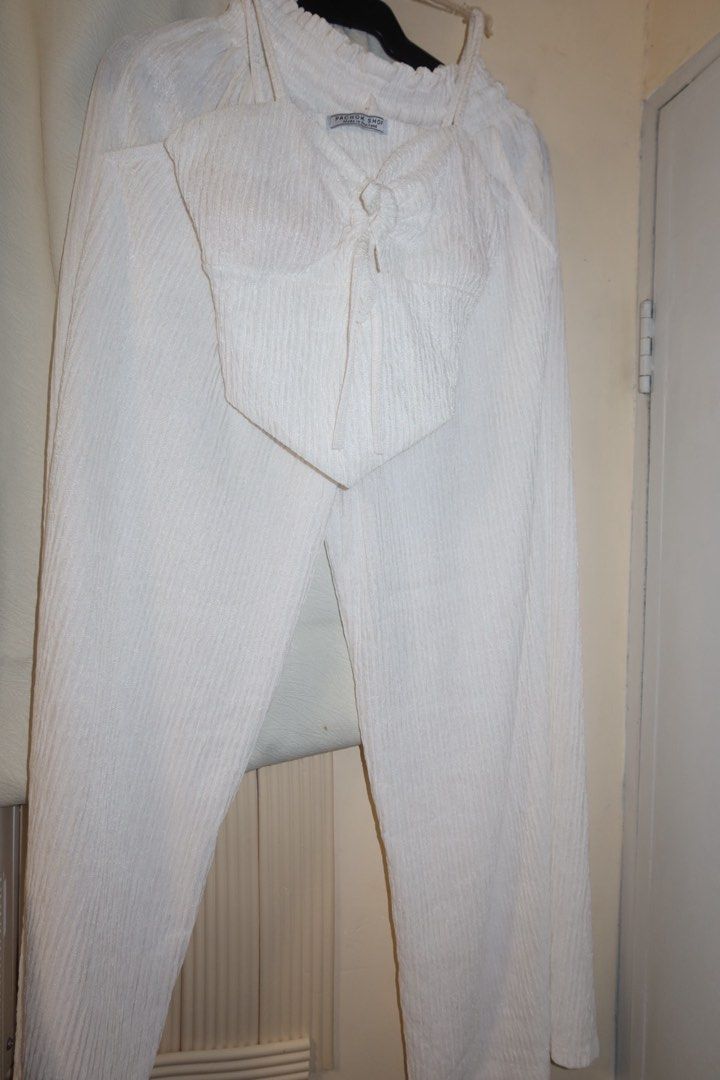 Pachok Shop White Crinkle Coordinates Set (Category: Sets or Coordinates) located in Cavite. Submitted by mcjkim (Listing ID 1469556905, Image 2). Description: - Brand: Pachok Shop (Made in Thailand) - Color: White - Set includes: Cropped tie-front cami top and high-waist wide-leg pants - Material: Super lightweight and breezy crinkle textured fabric - Fit features: Elastic waistband on pants for extra comfort - Condition: Worn only twice - Perfe