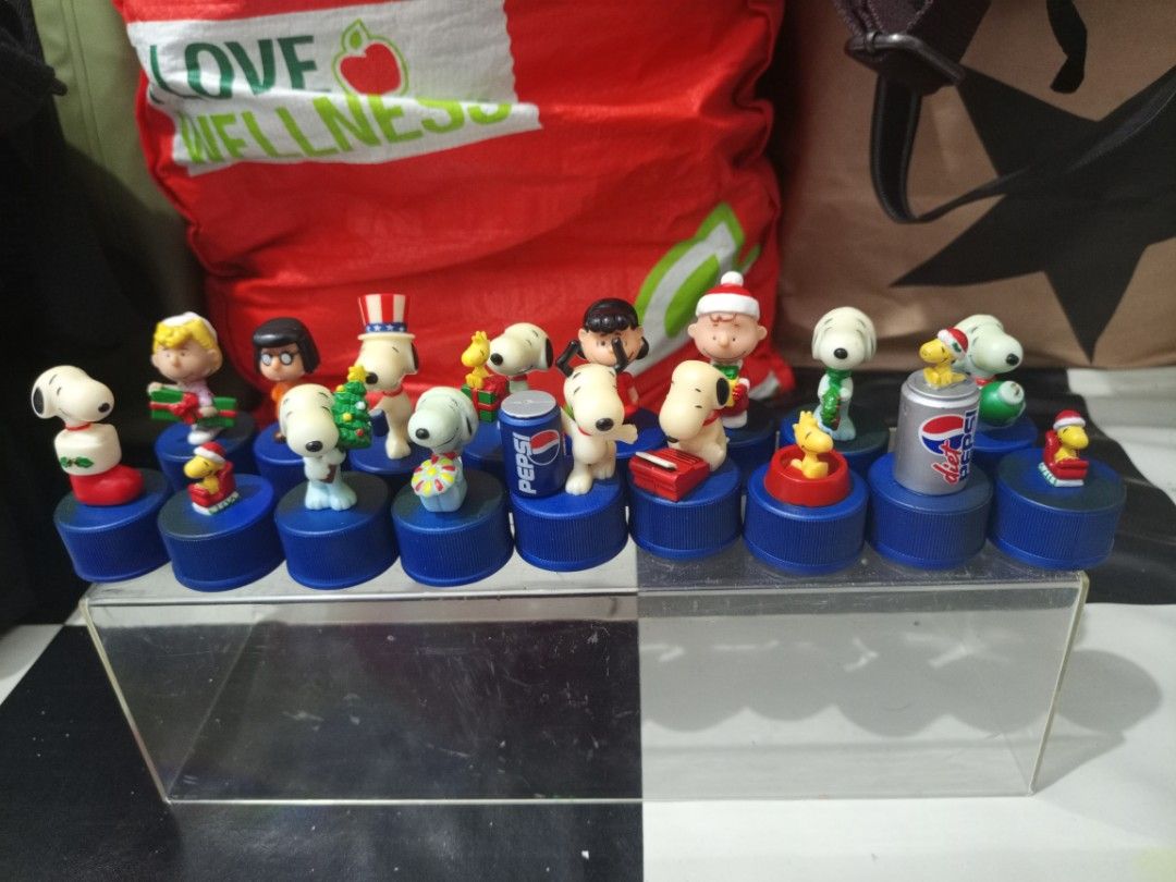 Peanuts Snoopy Christmas Pepsi Bottle Cap Figures Set (Category: Vintage Collectibles) located in Manila. Submitted by warmcrystal_269010 (Listing ID 1469550917, Image 1). Description: - Set of official Peanuts mini figures on blue Pepsi bottle caps - Features Snoopy, Charlie Brown, Woodstock, and holiday-themed gang members - Authentic promotional items with copyright stamps underneath - Sold as a complete lot, perfect for Peanuts collectors.