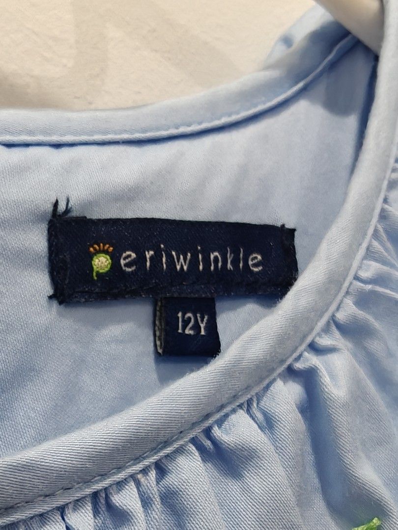 Periwinkle Blue Smocked Dress Size 12Y (Category: Babies & Kids Fashion) located in Cebu City. Submitted by periwinkletwinkles (Listing ID 1469448570, Image 3). Description: - Brand: Periwinkle - Size: 12Y (fits older kids) - Color: Light Blue - Material: 100% Cotton - Design: Smocked chest with tiny floral embroidery, white ruffled collar, and puffed short sleeves - Closure: Back buttons with a matching attached waist sash - Condition: Excellent
