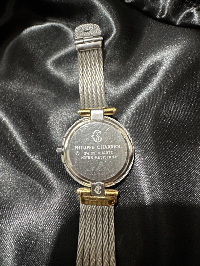 Philippe Charriol Swiss Quartz Watch (Category: Women's Watches) located in Makati City. Submitted by shebree (Listing ID 1469544801, Image 2). Description: - Brand: Philippe Charriol - Design: Two-tone silver and gold finish with iconic cable strap -Authentic Issue: Not working, needs machine replacement.