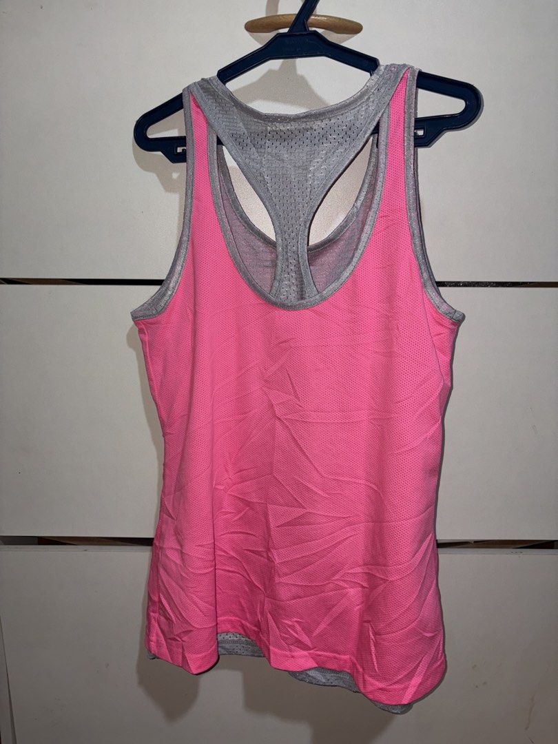 Pink and Grey Mesh Athletic Tank Top (Category: Sleeveless) located in Siquijor. Submitted by yhostuff (Listing ID 1469496178, Image 2). Description: - Vibrant neon pink outer layer with a cool grey mesh racerback inner layer - Made from breathable pinhole fabric for ultimate airflow - Lightweight and designed with a comfortable relaxed fit - Ideal for runs, gym sessions, and active workouts - Condition: Excellent / Like new.