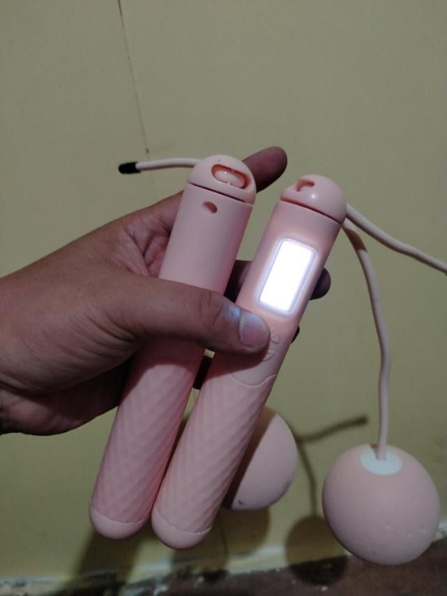 Pink Digital Cordless Jump Rope with Counter (Category: Cardio & Fitness Machines) located in Caloocan City. Submitted by marco.antor (Listing ID 1469409991, Image 2). Description: - Color: Pink - Type: Cordless digital jump rope with weighted balls - Best For: Indoor workouts and small spaces - Display: Bright, battery-powered LCD screen that tracks jumps - Comfort: Textured grip handles for easy holding.