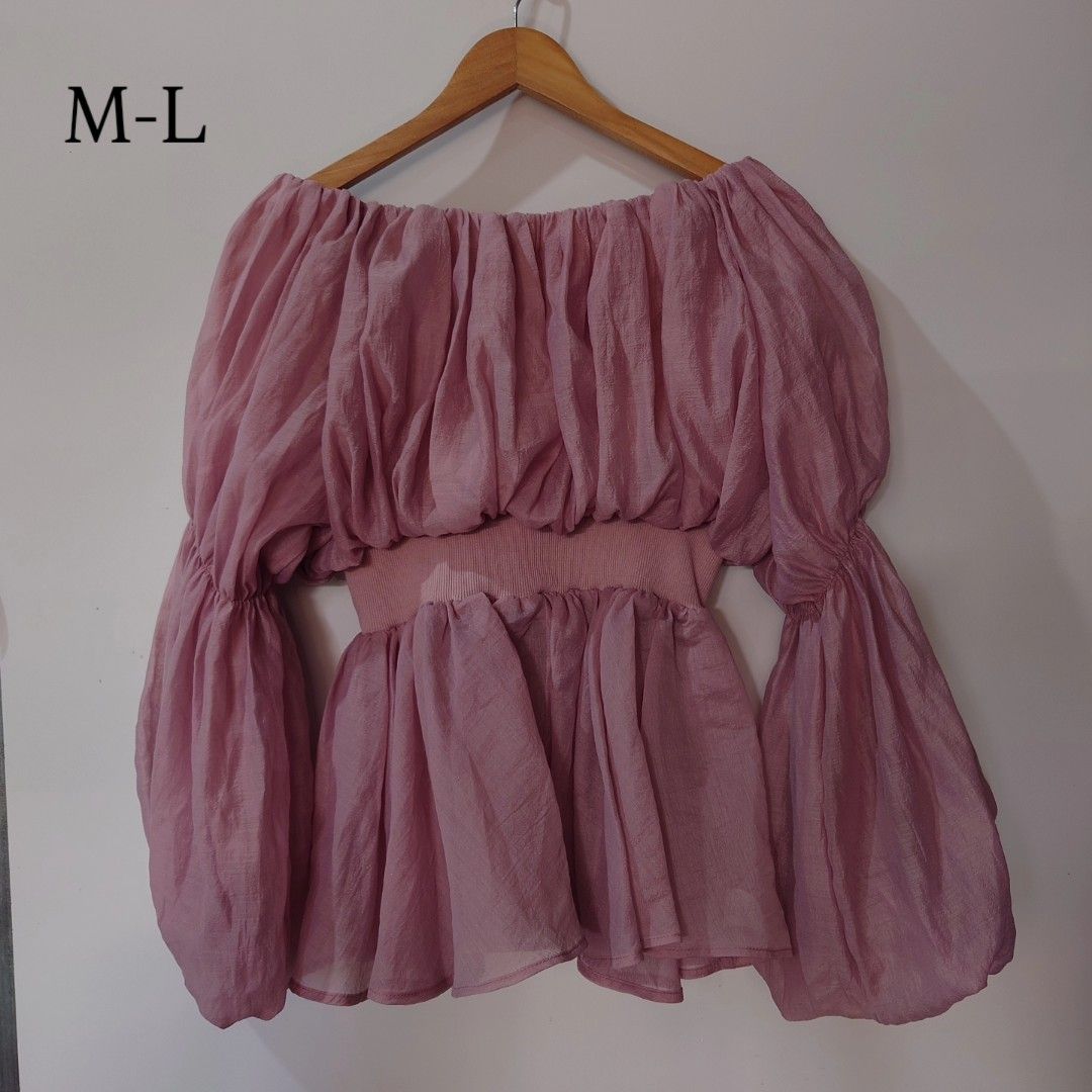 Pink off-shoulder gathered ruffle long sleeve blouse (Category: Blouses) located in Diffun. Submitted by declutteredbyJill (Listing ID 1469571127, Image 1). Description: - Color: Dusty pink - Style: Off-shoulder with all-over ruffles and voluminous long sleeves - Fit: Stretchy banded waist with a great draped fit (fits M to L) - Material: Lightweight and comfortable.