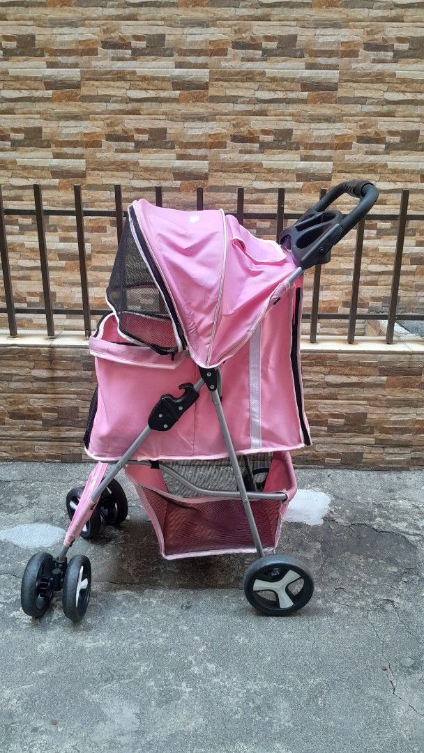 Pink Pet Stroller with Storage Basket (Category: Homes & Other Pet Accessories) located in Manila. Submitted by ysabellugh (Listing ID 1469525930, Image 1). Description: SECONDHAND PAW SMART PET STROLLER FOR SALE 🛒 ₱900 (originally bought ₱2000) RFS: Decluttering, our dogs have outgrown the stroller already 🐾 Item Details - Condition: 7.5/10 - Max Weight Capacity: 25 KG - Secondhand and well-used but still functional. - Material: pastel pink ca