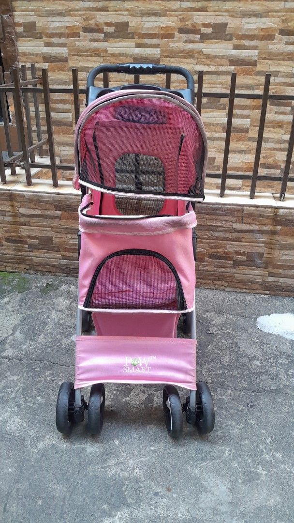 Pink Pet Stroller with Storage Basket (Category: Homes & Other Pet Accessories) located in Manila. Submitted by ysabellugh (Listing ID 1469525930, Image 2). Description: SECONDHAND PAW SMART PET STROLLER FOR SALE 🛒 ₱900 (originally bought ₱2000) RFS: Decluttering, our dogs have outgrown the stroller already 🐾 Item Details - Condition: 7.5/10 - Max Weight Capacity: 25 KG - Secondhand and well-used but still functional. - Material: pastel pink ca