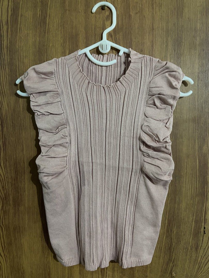 Pink Ruffle Sleeveless Ribbed Knit Top (Category: Sleeveless) located in Caloocan City. Submitted by lovedbyryu (Listing ID 1469458832, Image 1). Description: - Color: Pink - Style: Sleeveless ribbed knit top with cute ruffled shoulders - Neckline: Classic crew neck - Fit: Stretchy fabric that hugs the body comfortably - Versatility: Great for solo wear or layering under jackets - Condition: Brand new / Excellent.