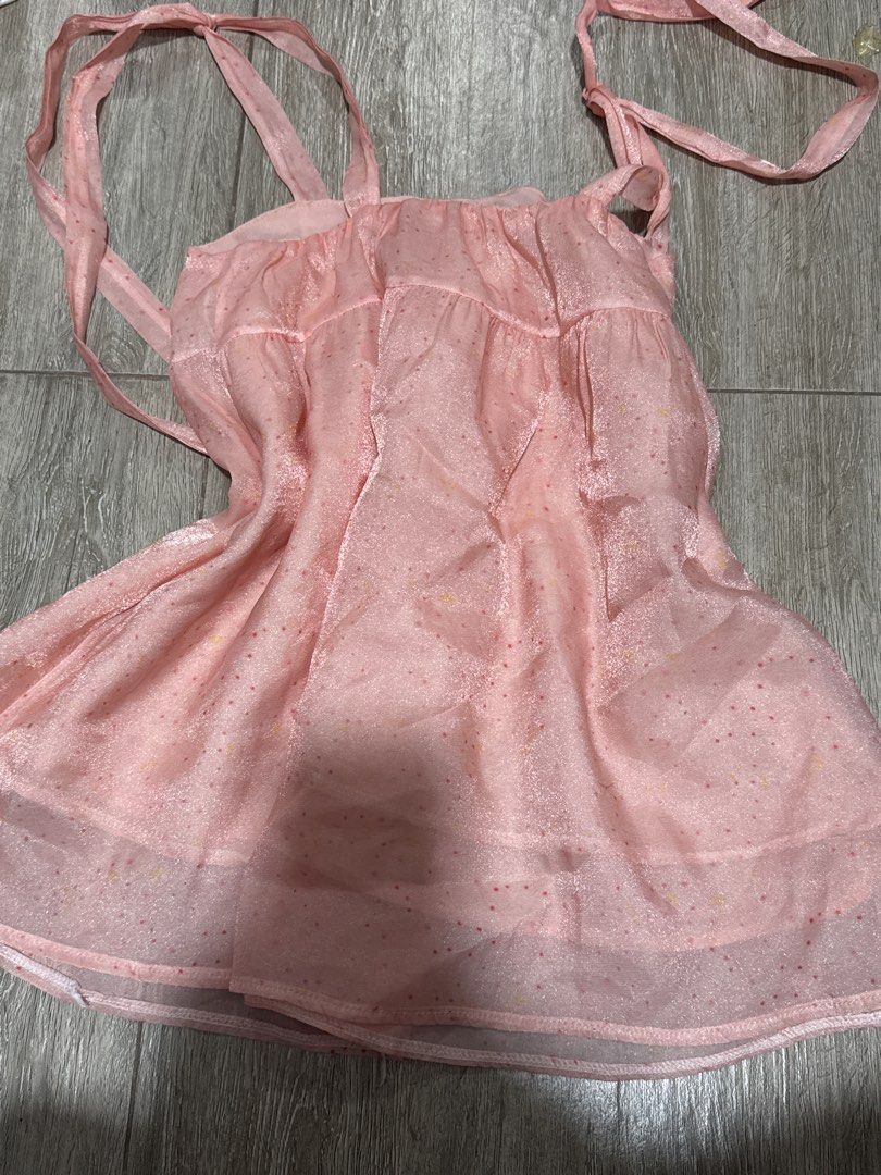 Pink Sparkly Polka Dot Cami Top With Ties (Category: Sleeveless) located in Pateros City. Submitted by sophiahipolito (Listing ID 1469522214, Image 2). Description: - Color & Material: Light pink sheer fabric with a subtle sparkle - Pattern: All-over tiny red and yellow polka dots - Straps & Sides: Adjustable ribbon tie straps at shoulders and sides - Design: Layered ruffle hem for a sweet, feminine look - Style: Lightweight and breezy, perfect f