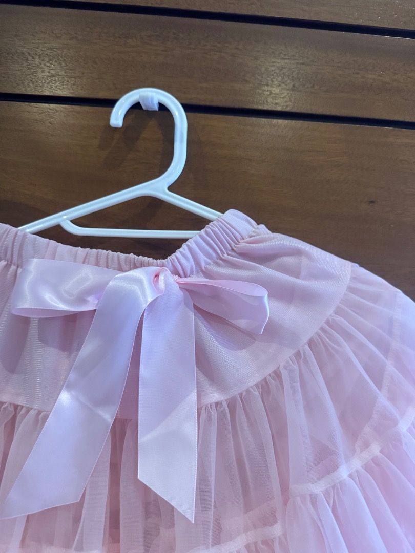 Pink tutu skirt with satin bow (Category: Babies & Kids Fashion) located in Paranaque City. Submitted by southmomma (Listing ID 1469485854, Image 2). Description: - Color: Pink - Fits 5-6 years old - Material: Lightweight tulle with multiple layered ruffles - Features: Comfortable stretchable elastic waistband - Accents: Cute satin ribbon bow at the front - Perfect for: Dress-up, parties, and photo shoots.