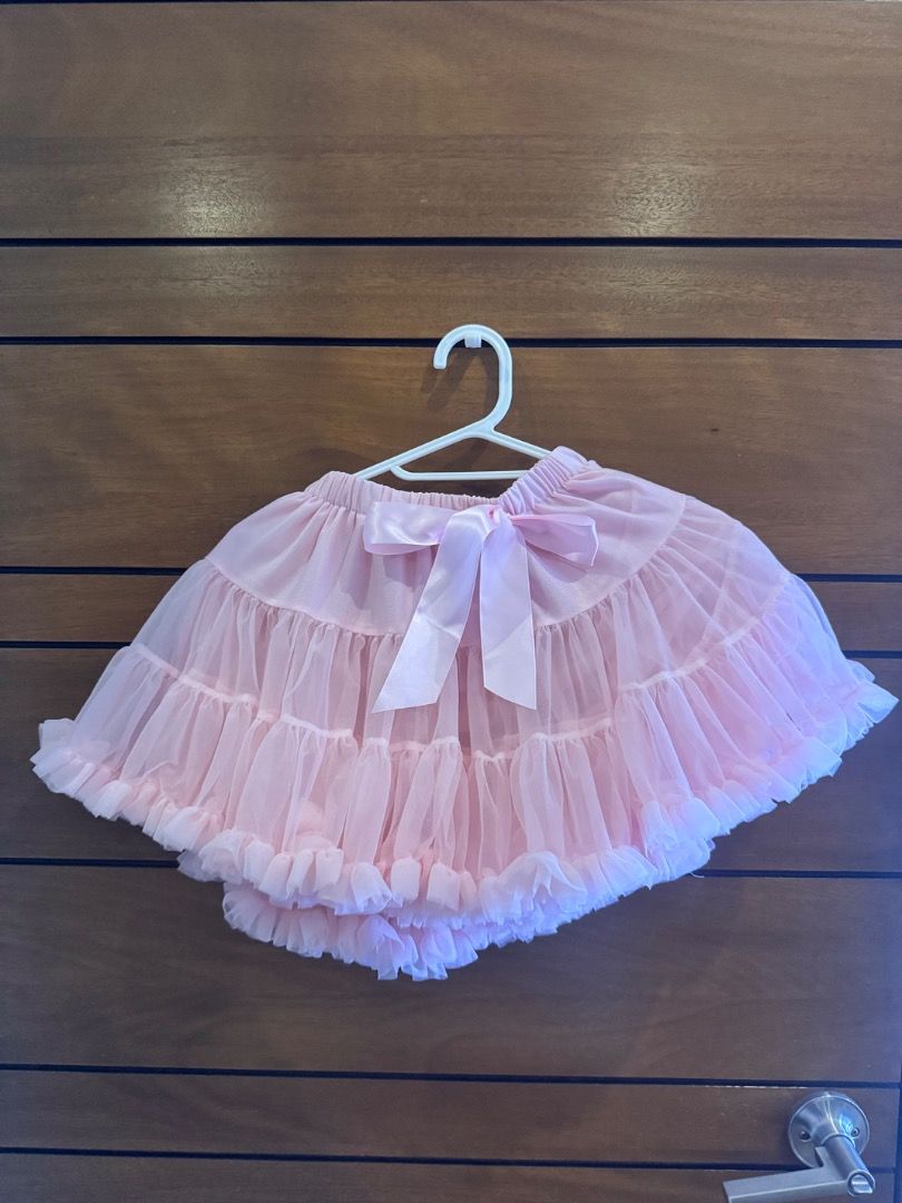 Pink tutu skirt with satin bow (Category: Babies & Kids Fashion) located in Paranaque City. Submitted by southmomma (Listing ID 1469485854, Image 1). Description: - Color: Pink - Fits 5-6 years old - Material: Lightweight tulle with multiple layered ruffles - Features: Comfortable stretchable elastic waistband - Accents: Cute satin ribbon bow at the front - Perfect for: Dress-up, parties, and photo shoots.