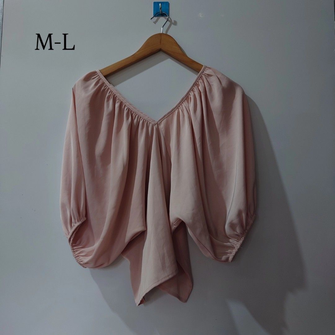 Pink V-Neck Short Sleeve Blouse (Category: Blouses) located in Diffun. Submitted by declutteredbyJill (Listing ID 1469570366, Image 1). Description: - Color: Pink - Size: M-L - Neckline: V-neck with gathered pleats - Sleeves: Voluminous with elastic cuffs - Hem: Asymmetrical (longer in the front) - Fabric: Lightweight and flowy - Condition: Excellent / Brand New.