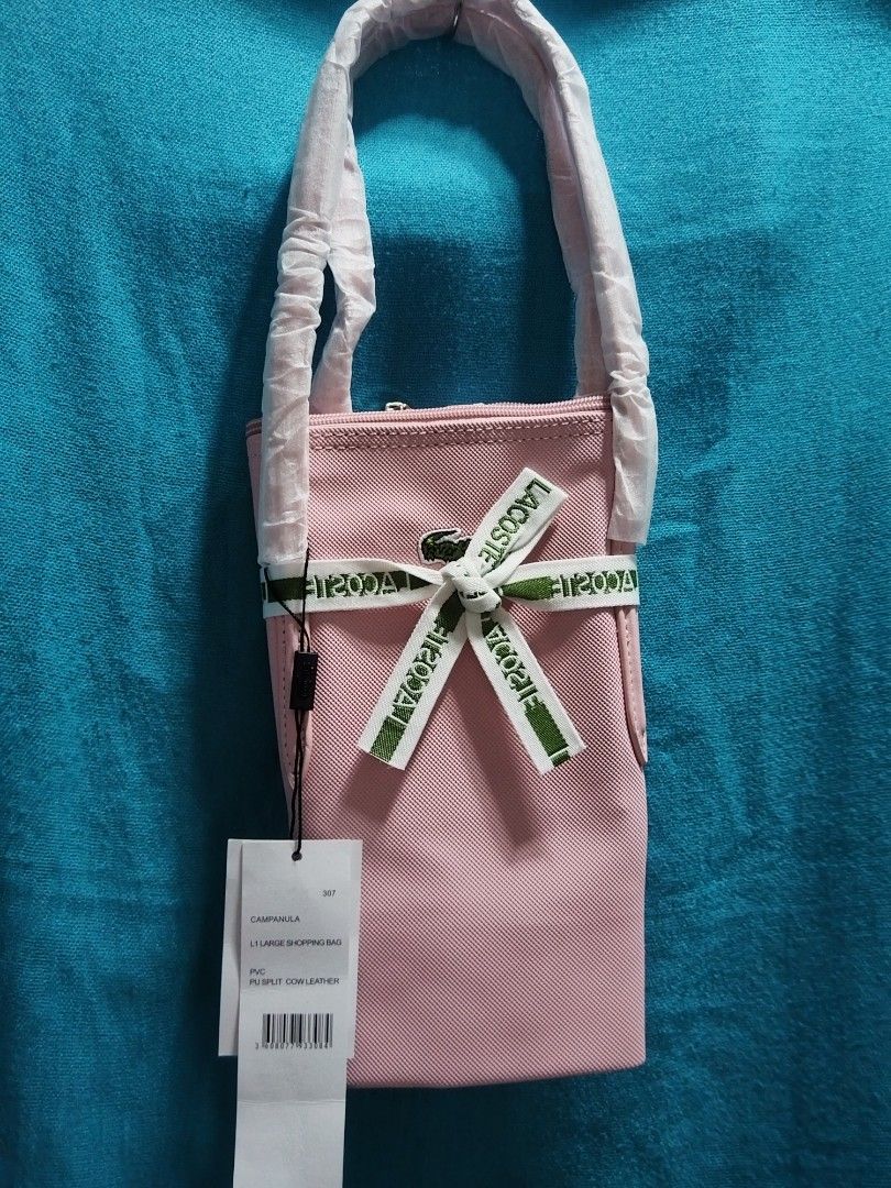 Pinky Lac Medium Tote Bag (Category: Tote Bags) located in Las Pinas. Submitted by jpmshoppe (Listing ID 1469466513, Image 2). Description: Lacost Medium Tote PVC material Pink in color.