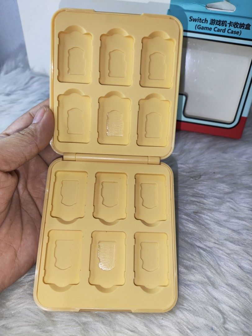 Pokémon Pikachu Nintendo Switch Game Card Case 12 Slots (Category: Trading Cards Accessories) located in Cavite. Submitted by tinetaclesss (Listing ID 1469499714, Image 2). Description: - Color: Bright yellow with cute Pikachu and Bulbasaur cover graphics - Capacity: Securely holds up to 12 Nintendo Switch game cartridges in molded slots - Packaging: Includes original retail box - Perfect for safe storage and portable gaming.