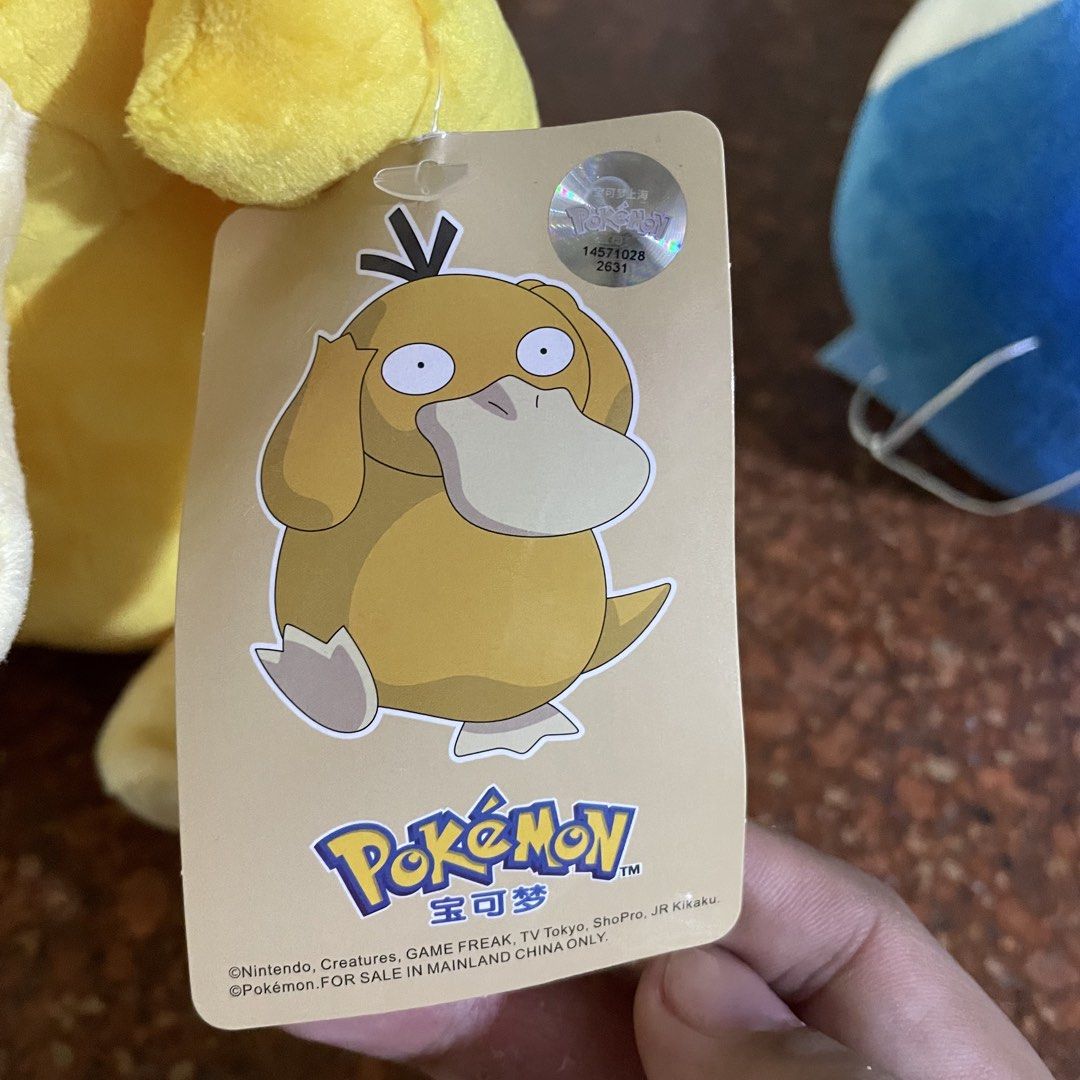 Pokémon Psyduck Plush Toy with Tag (Category: Plushies & Soft Toys) located in Manila. Submitted by jemiruxd (Listing ID 1469511354, Image 2). Description: - Authentic Pokémon collection Psyduck plush toy - Features iconic blank expression, wide beak, and black hair tufts - Made with super soft fabric all over - Includes original hanging tag with authenticity sticker - Comes with a rare sewn-in error label on the side - Standard size, clean, and 