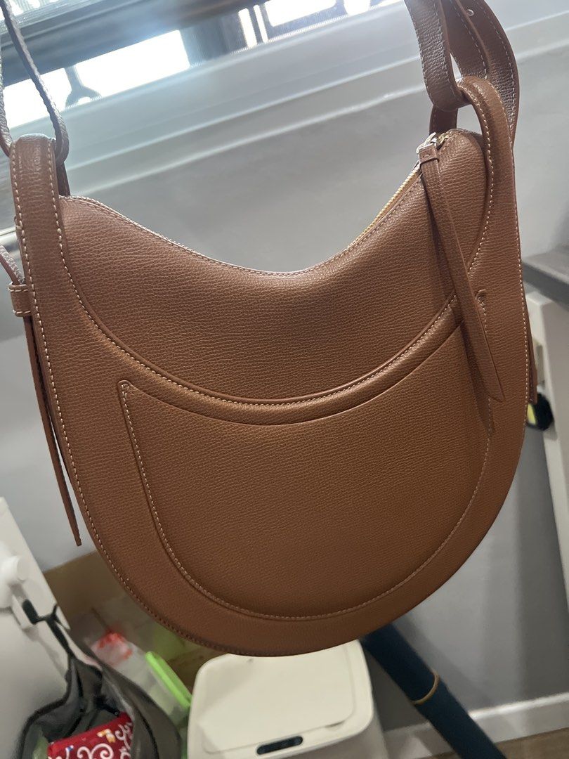 Polene authentic bag (Category: Shoulder Bags) located in Manila. Submitted by cosmic_preloved_mnl (Listing ID 1469466646, Image 1). Description: - Material: Premium brown pebbled leather - Design: Stylish curved silhouette with contrast stitching and front pocket flap - Closure: Secure top zipper closure - Strap: Adjustable shoulder strap with durable metal hardware - Interior: Clean lining with a practical everyday size - Mode of Payment: GCash