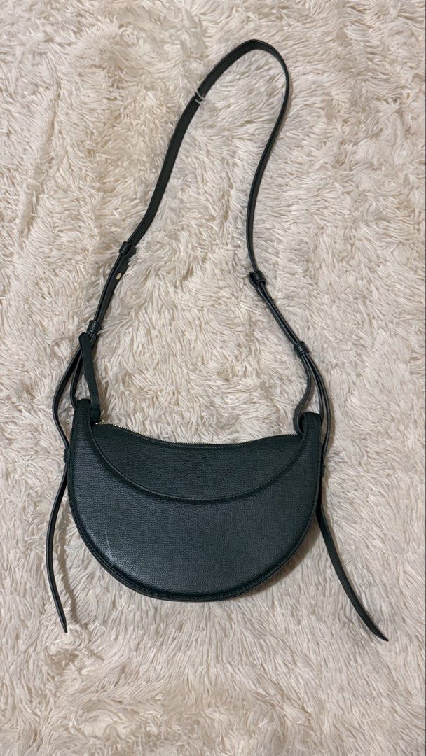 Polene Numero Dix Green (Category: Luxury Bags & Wallets) located in Pasay City. Submitted by erinsclosetph (Listing ID 1469421369, Image 2). Description: Polène Numéro Dix – Green Pre-loved Polène Numéro Dix in green, worn crossbody. Shows signs of wear, including stains and scratches on the leather. Lining and piping are in great condition, with a clean interior. Inclusions: None .