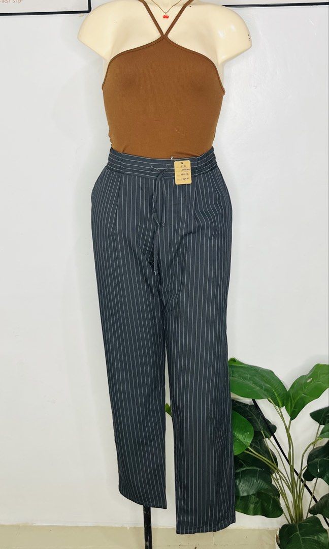 Polham Pinstripe Trousers Drawstring Waist Dark Grey (Category: Other Bottoms) located in Manila. Submitted by bengirlclothing (Listing ID 1467178537, Image 2). Description: - Brand: Polham -Size: 28-30 inches -Length: 36 inches - Color/Pattern: Dark grey with thin white pinstripes - Fit: Straight-leg cut - Waistband: Elasticated with adjustable drawstring - Pockets: Includes a back pocket with button closure - Style: Casual yet smart, perfect fo