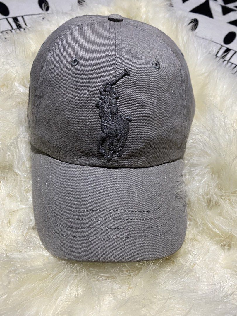Polo Ralph Lauren Grey Baseball Cap (Category: Caps & Hats) located in Badiangan. Submitted by iralorana.thrift (Listing ID 1469419499, Image 2). Description: - Brand: Ralph Lauren - Color: Classic Grey - Details: Embroidered front logo, signature number 3 on the right side, and POLO text above the back strap - Fit: Adjustable metal buckle closure with a curved brim.