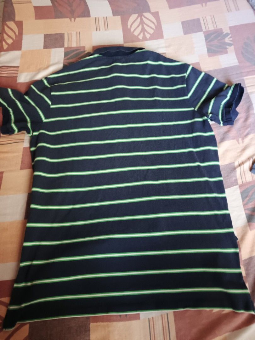 Polo Ralph Lauren. Polo shirts (Category: Activewear) located in Odiongan. Submitted by thriftngo26 (Listing ID 1469403579, Image 3). Description: This is a Polo Ralph Lauren striped short-sleeve polo shirt. It features a classic horizontal stripe pattern alternating between navy blue and bright/lime green, accented by the iconic embroidered pony logo on the left chest in hot pink.