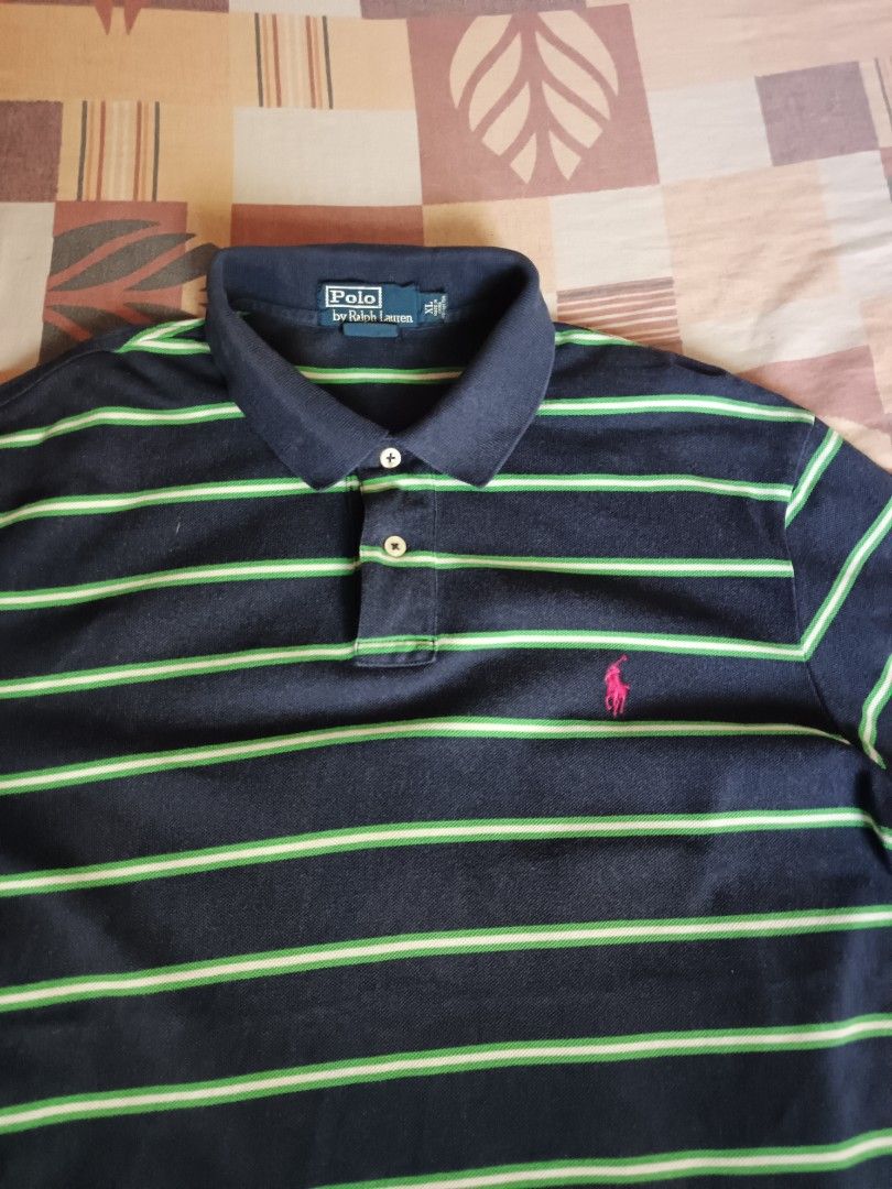 Polo Ralph Lauren. Polo shirts (Category: Activewear) located in Odiongan. Submitted by thriftngo26 (Listing ID 1469403579, Image 2). Description: This is a Polo Ralph Lauren striped short-sleeve polo shirt. It features a classic horizontal stripe pattern alternating between navy blue and bright/lime green, accented by the iconic embroidered pony logo on the left chest in hot pink.