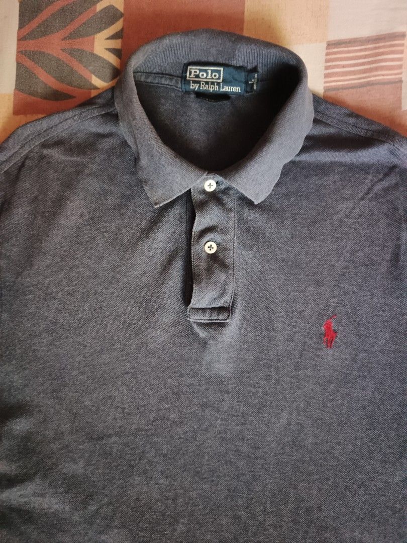 Polo Ralph Lauren poloshirt (Category: Activewear) located in Odiongan. Submitted by thriftngo26 (Listing ID 1469401823, Image 2). Description: This item is an authentic Polo Ralph Lauren Iconic Mesh Polo Shirt. It features a charcoal heather grey finish, a classic ribbed polo collar with a two-button placket, and the signature red embroidered Polo Pony emblem on the left chest..