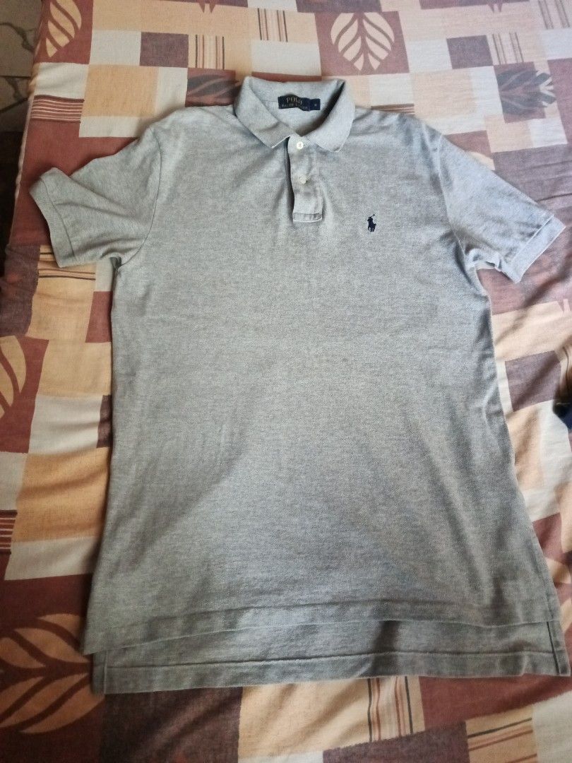 Polo Ralph Lauren poloshirt (Category: Activewear) located in Odiongan. Submitted by thriftngo26 (Listing ID 1469402113, Image 1). Description: The image shows a classic heather grey Polo Ralph Lauren short-sleeve polo shirt. It features the brand's signature embroidered pony logo on the left chest, a traditional two-button placket, a ribbed collar, and a split hem that is slightly longer in the back.